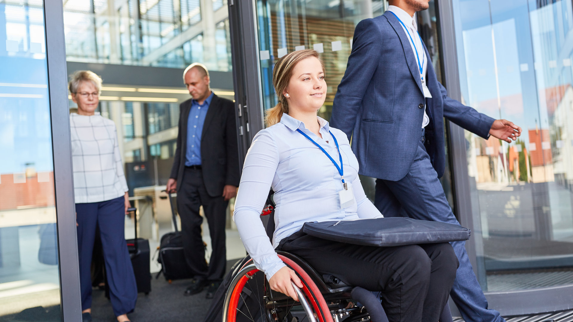 woman in wheelchair exiting building